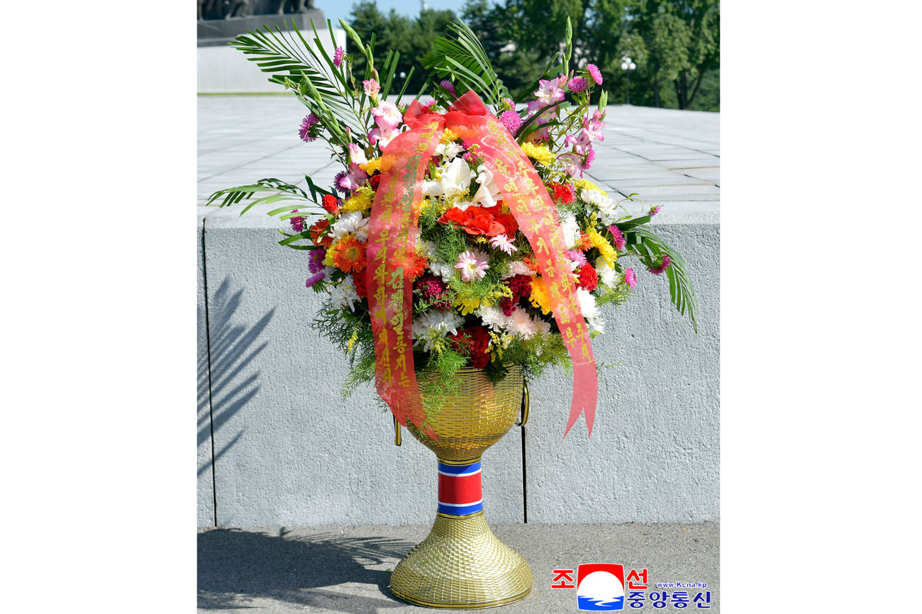 Floral baskets sent to bronze statues of great leaders Kim Il Sung and Kim Jong Il by Koreans in China