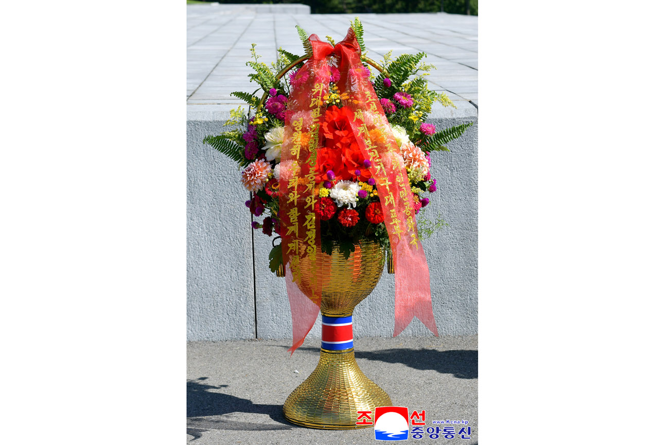 Floral baskets sent to bronze statues of great leaders Kim Il Sung and Kim Jong Il by Koreans in China