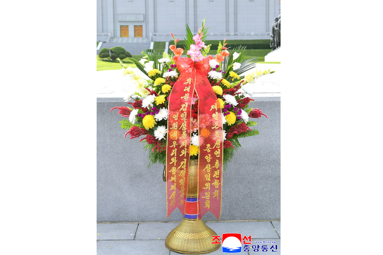 Floral baskets to bronze statues of great leaders Kim Il Sung and Kim Jong Il from overseas Koreans