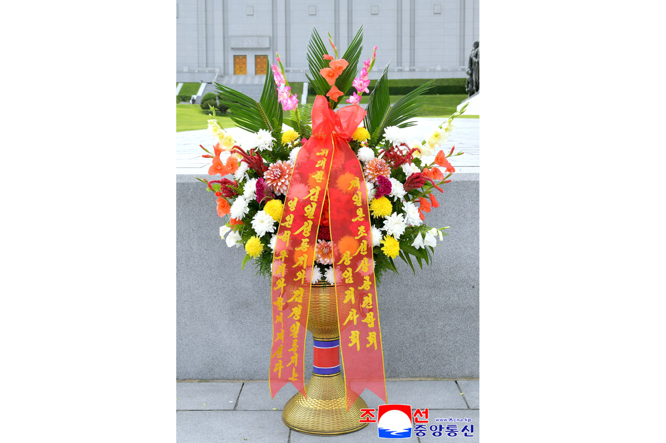 Floral baskets to bronze statues of great leaders Kim Il Sung and Kim Jong Il from overseas Koreans