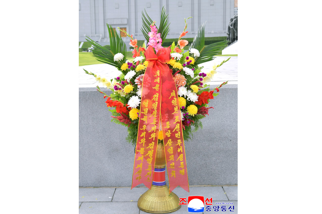 Floral baskets to bronze statues of great leaders Kim Il Sung and Kim Jong Il from overseas Koreans