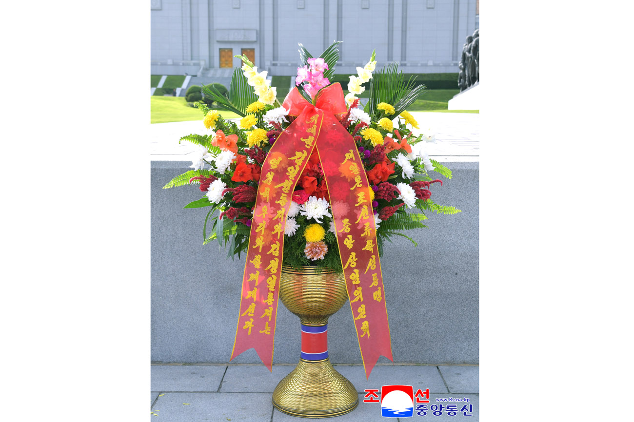 Floral baskets to bronze statues of great leaders Kim Il Sung and Kim Jong Il from overseas Koreans