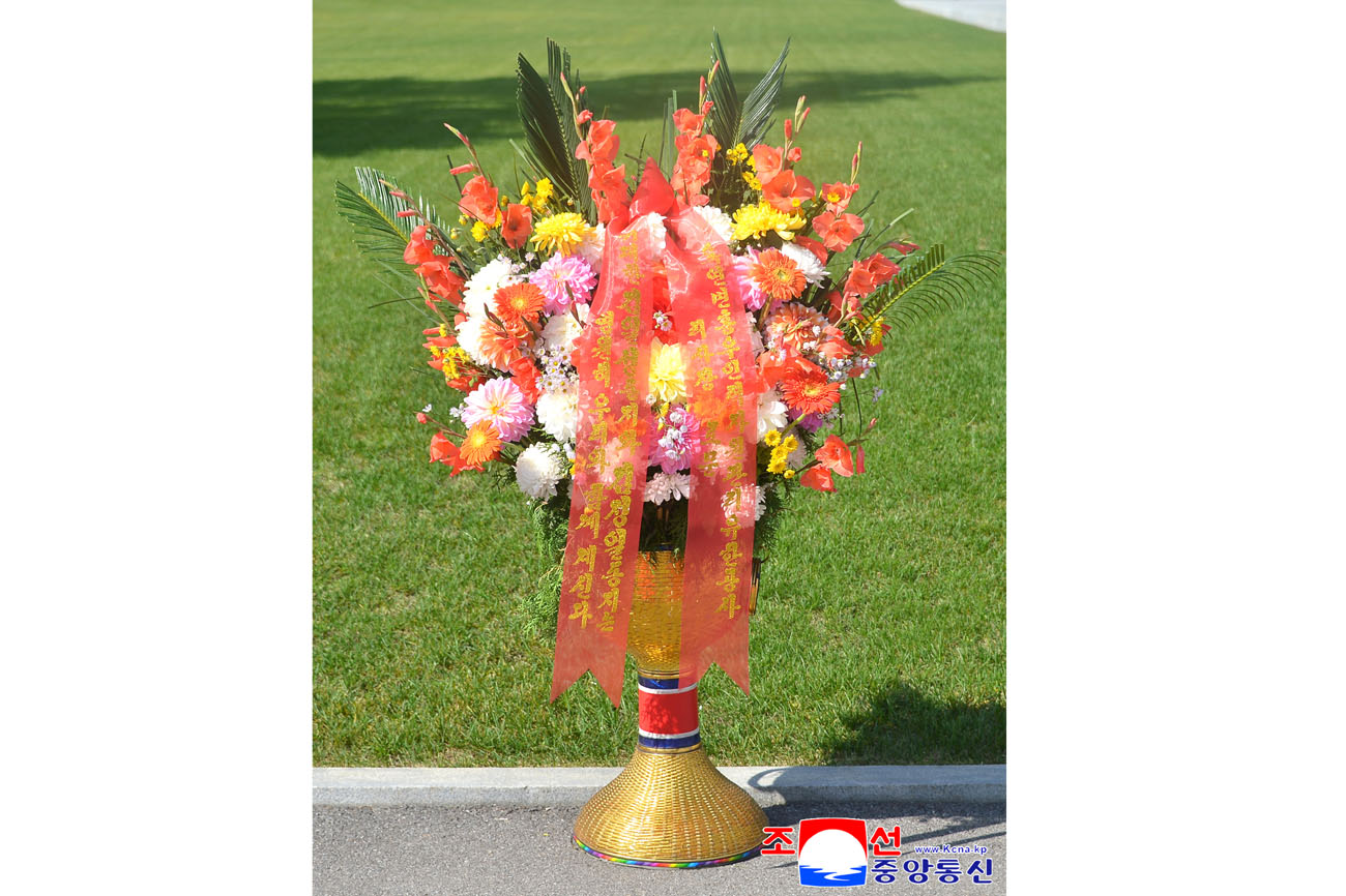 Floral baskets sent to bronze statues of great leaders Kim Il Sung and Kim Jong Il