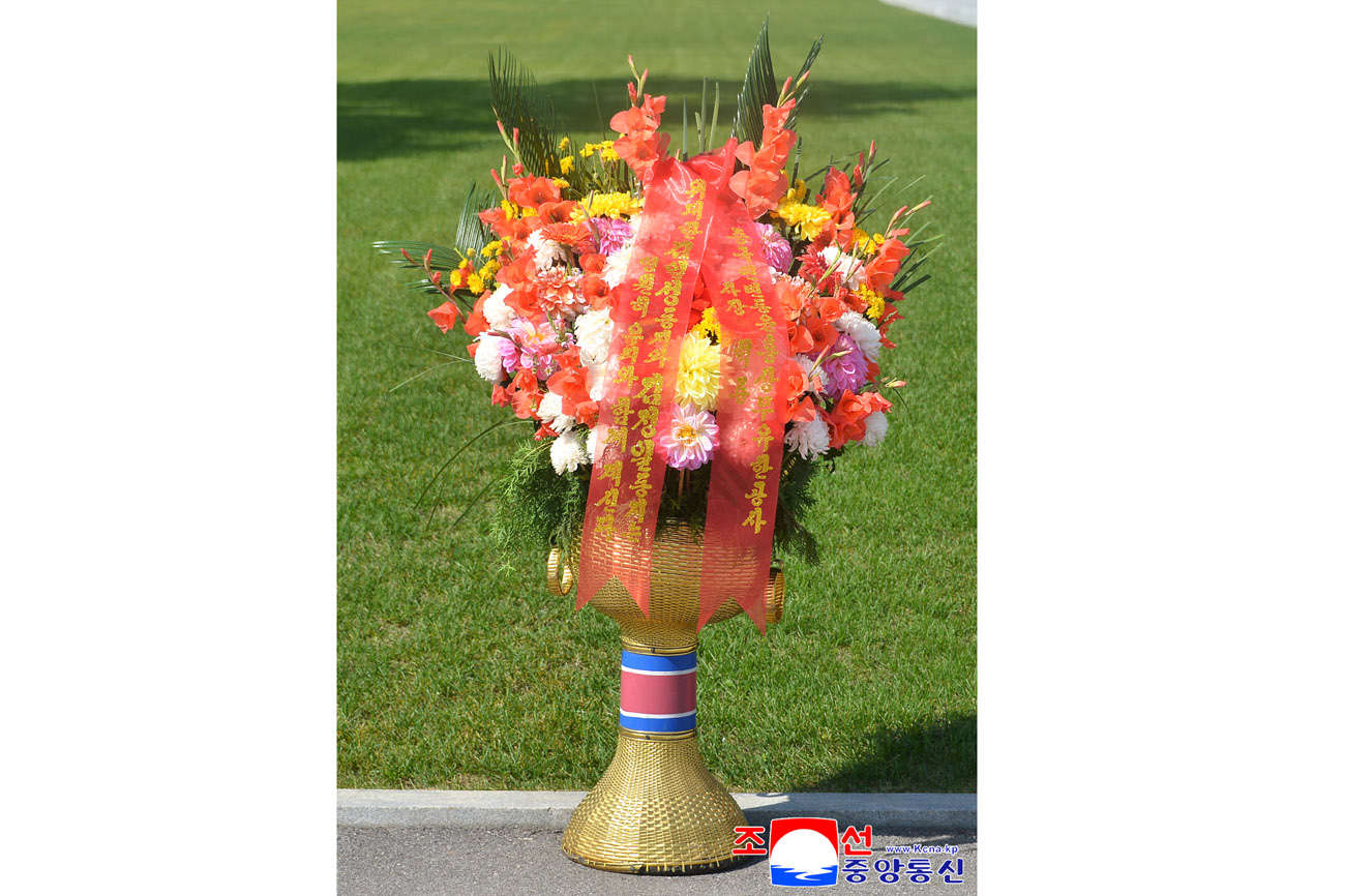 Floral baskets sent to bronze statues of great leaders Kim Il Sung and Kim Jong Il