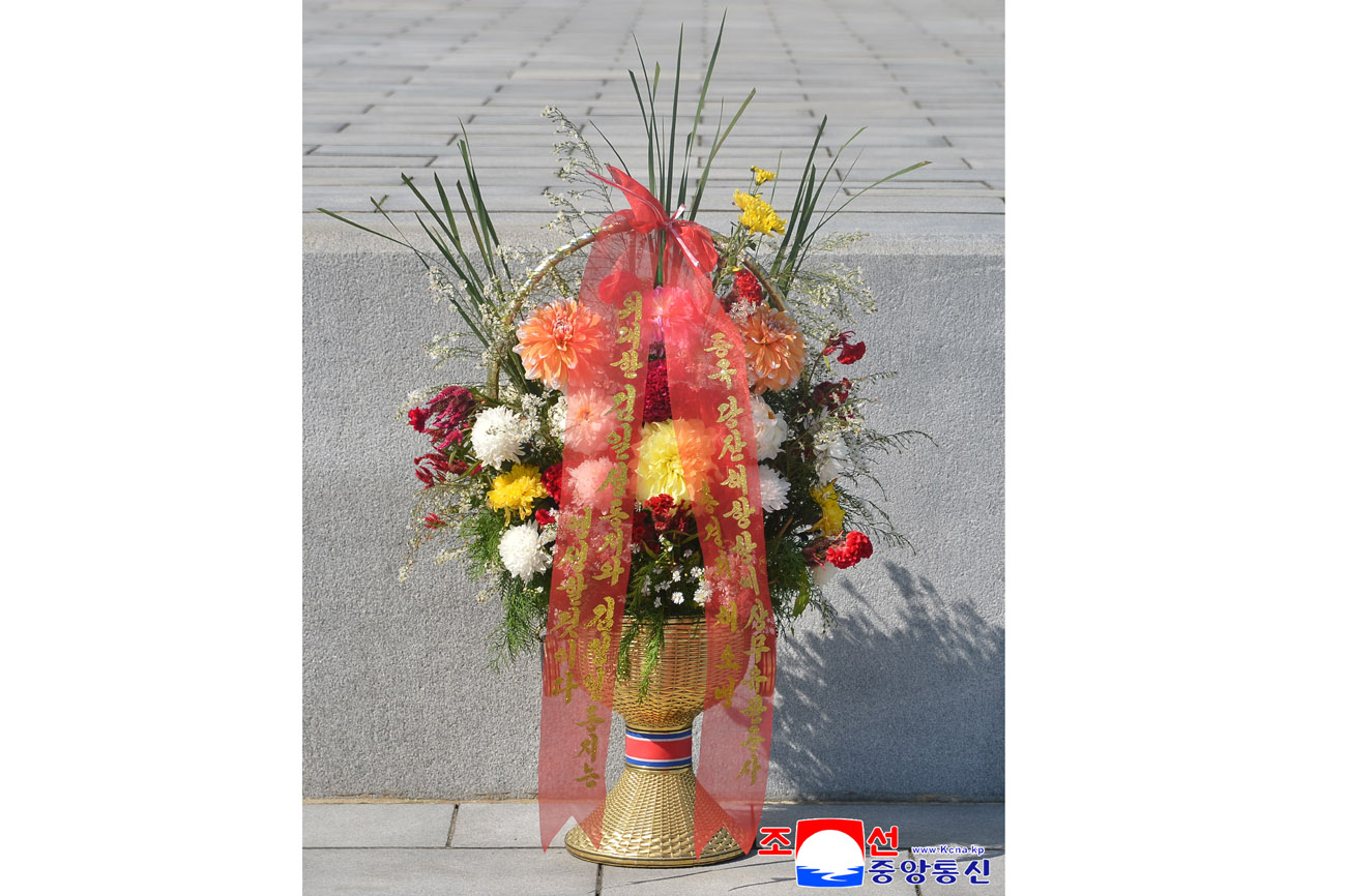 Floral baskets sent to bronze statues of great leaders Kim Il Sung and Kim Jong Il