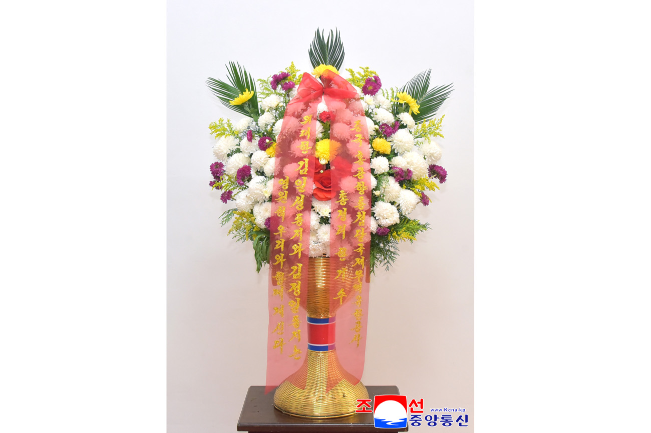 Floral baskets sent to bronze statues of great leaders Kim Il Sung and Kim Jong Il
