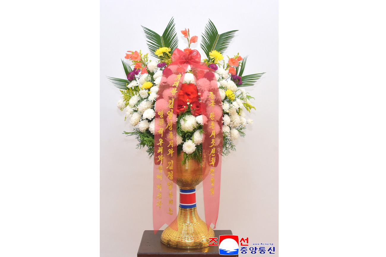 Floral baskets sent to bronze statues of great leaders Kim Il Sung and Kim Jong Il