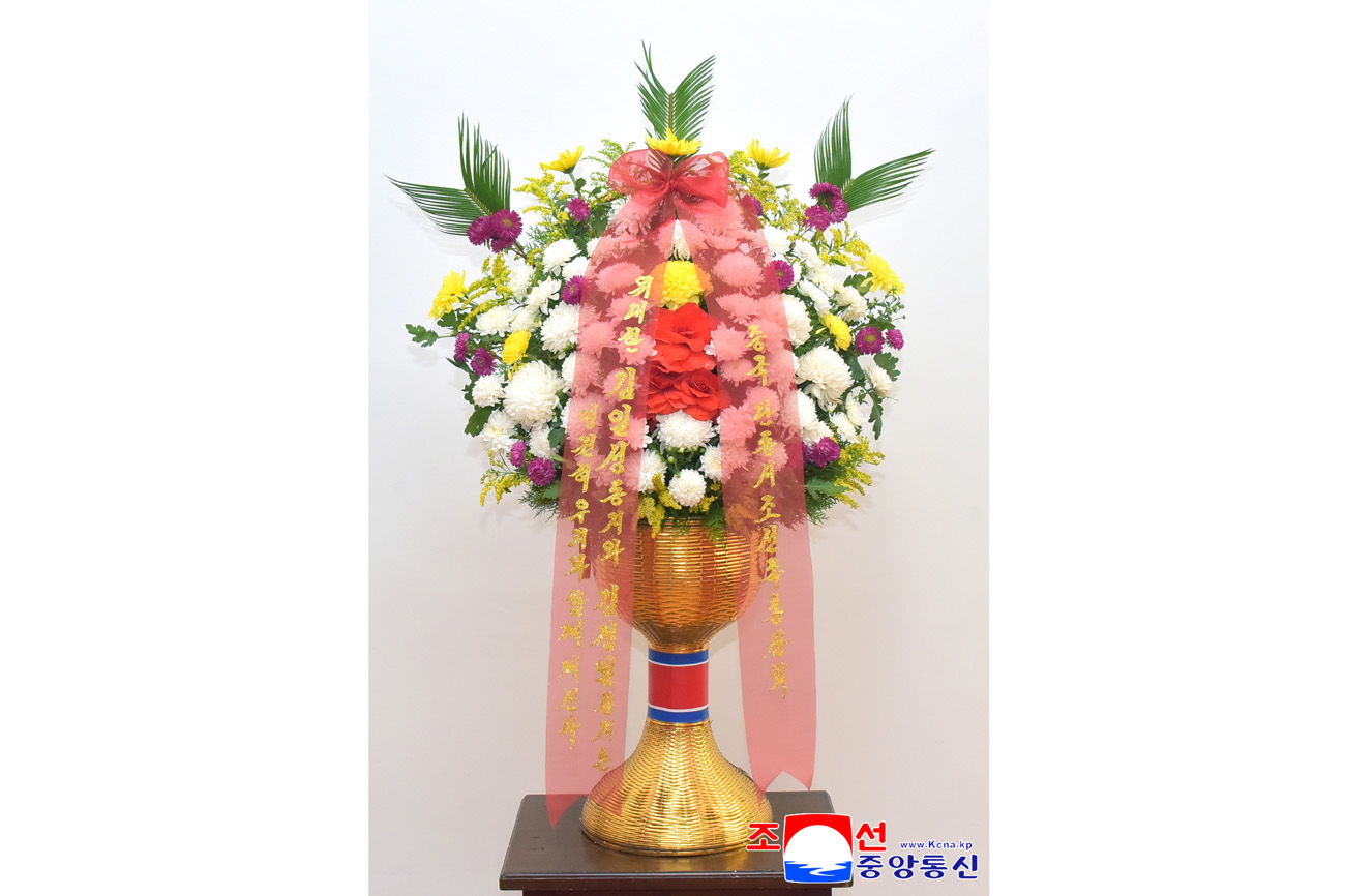 Floral baskets sent to bronze statues of great leaders Kim Il Sung and Kim Jong Il