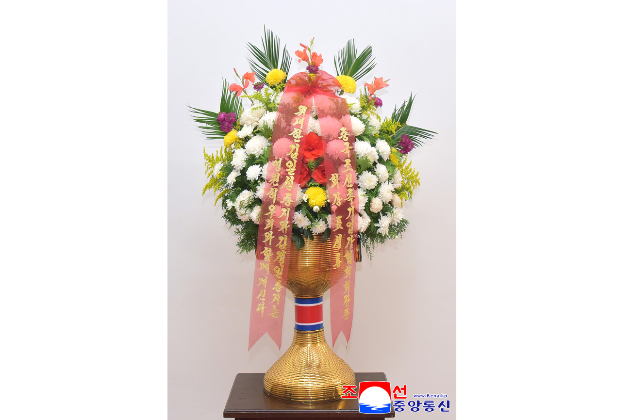 Floral baskets sent to bronze statues of great leaders Kim Il Sung and Kim Jong Il