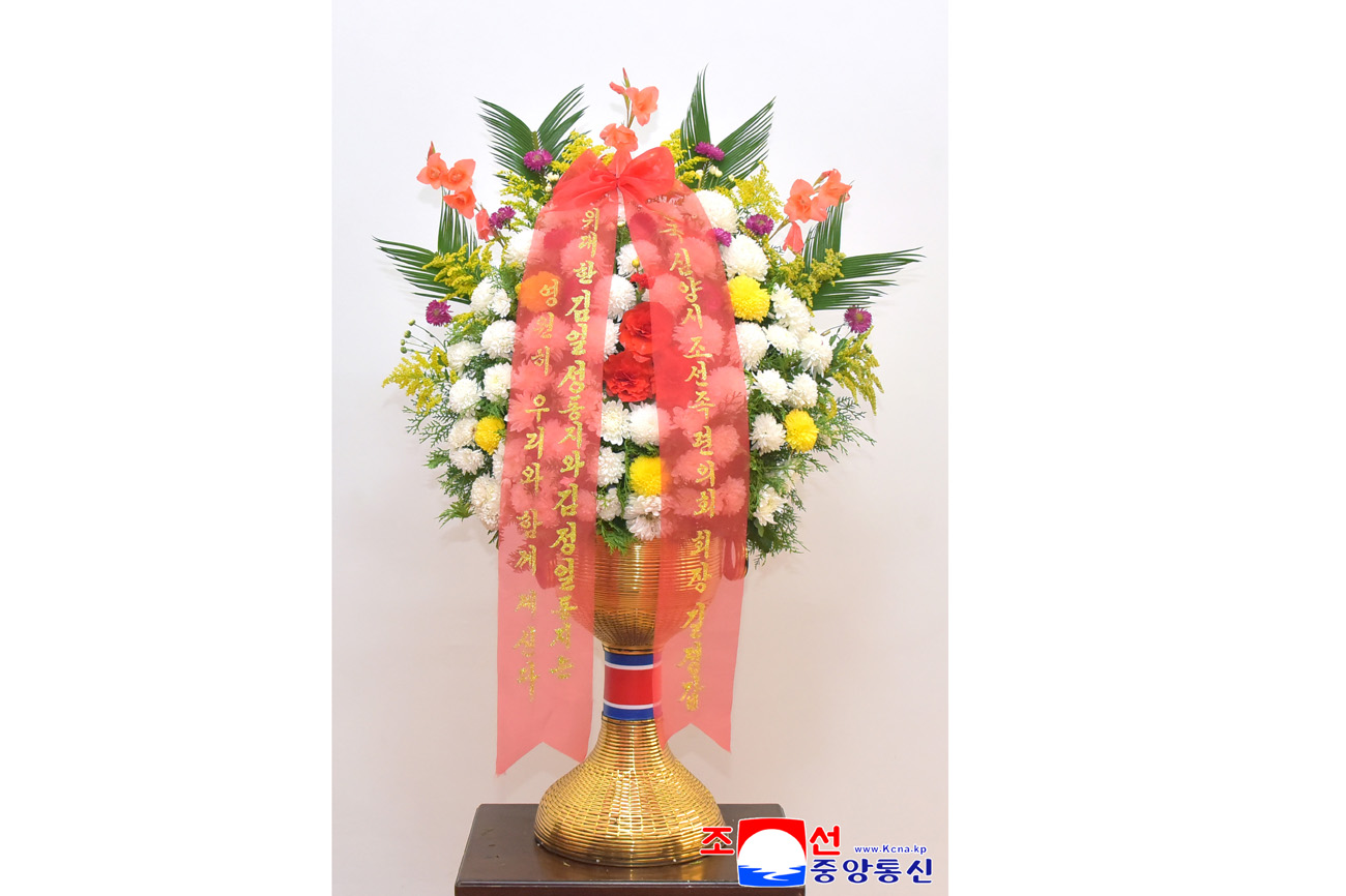 Floral baskets sent to bronze statues of great leaders Kim Il Sung and Kim Jong Il