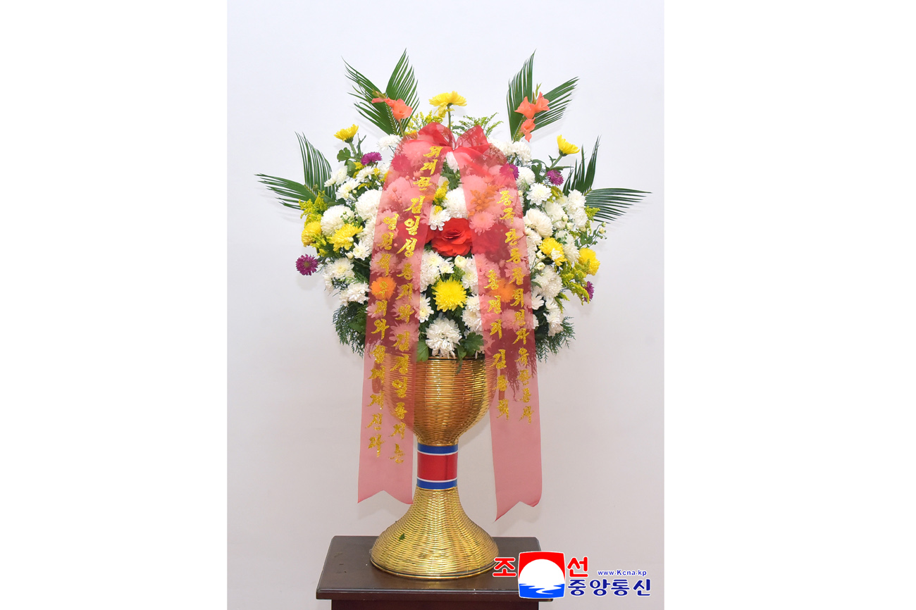 Floral baskets sent to bronze statues of great leaders Kim Il Sung and Kim Jong Il