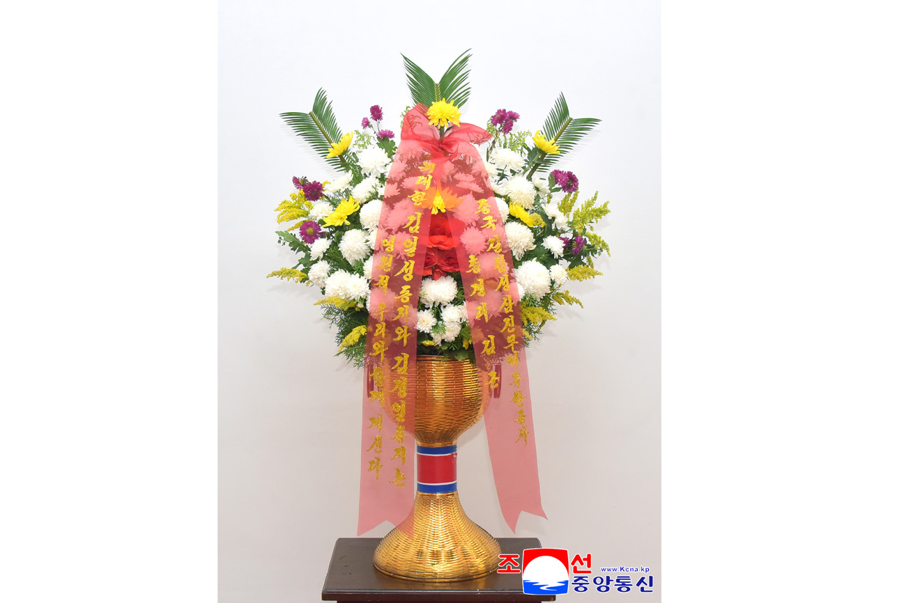 Floral baskets sent to bronze statues of great leaders Kim Il Sung and Kim Jong Il
