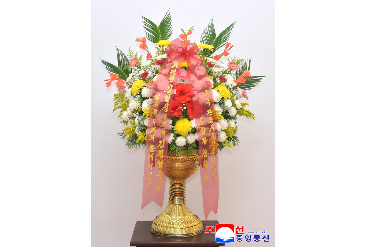 Floral baskets sent to bronze statues of great leaders Kim Il Sung and Kim Jong Il