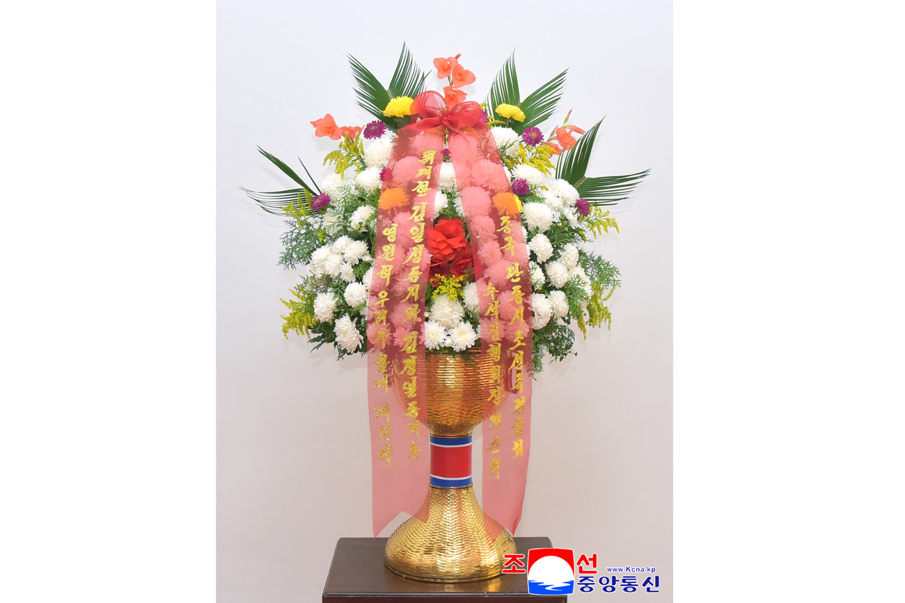 Floral baskets sent to bronze statues of great leaders Kim Il Sung and Kim Jong Il
