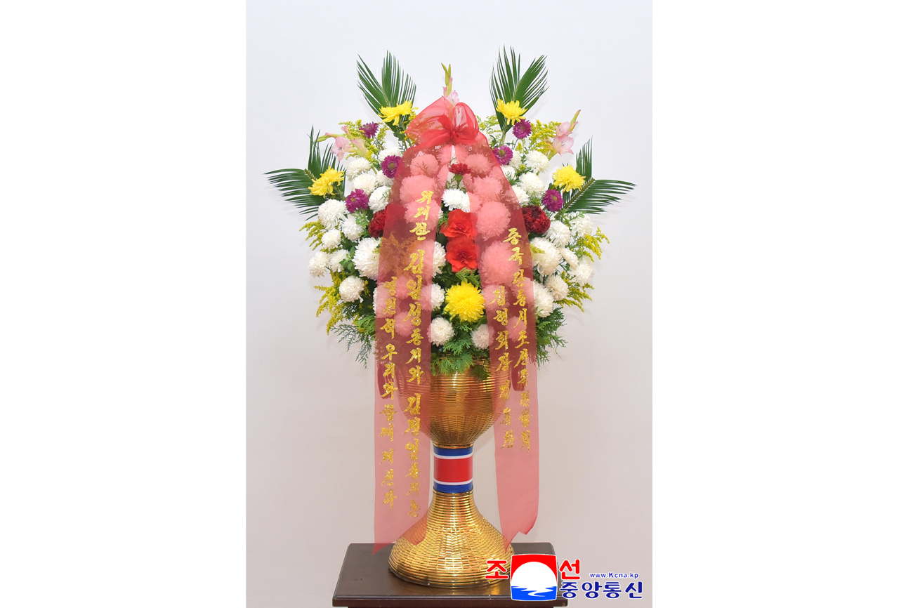 Floral baskets sent to bronze statues of great leaders Kim Il Sung and Kim Jong Il