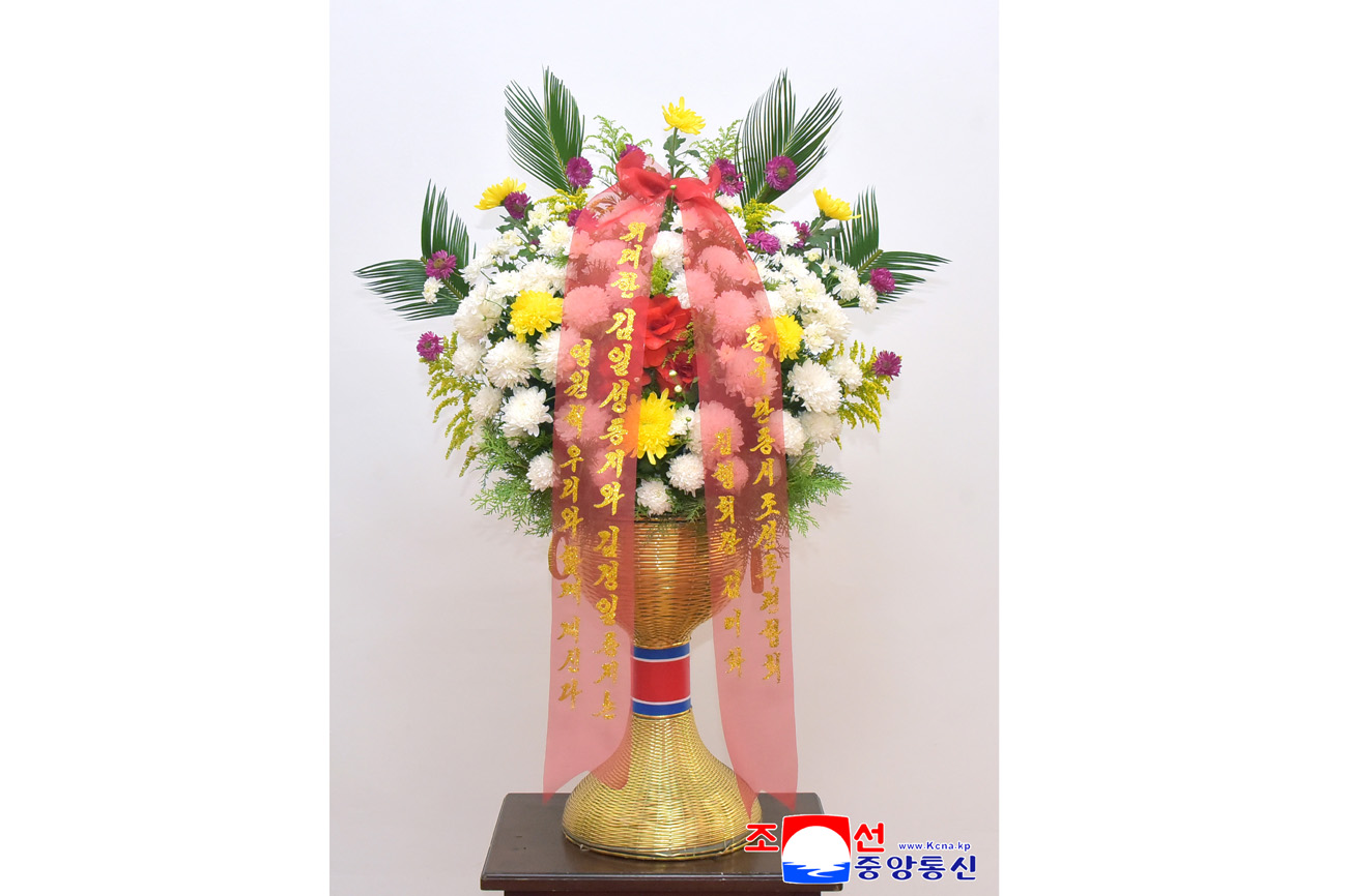 Floral baskets sent to bronze statues of great leaders Kim Il Sung and Kim Jong Il