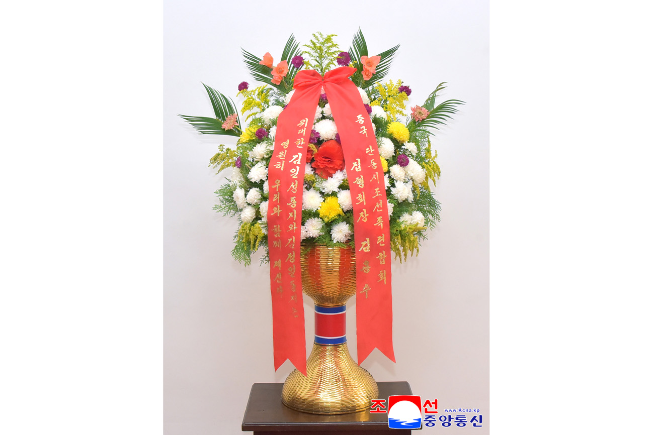 Floral baskets sent to bronze statues of great leaders Kim Il Sung and Kim Jong Il