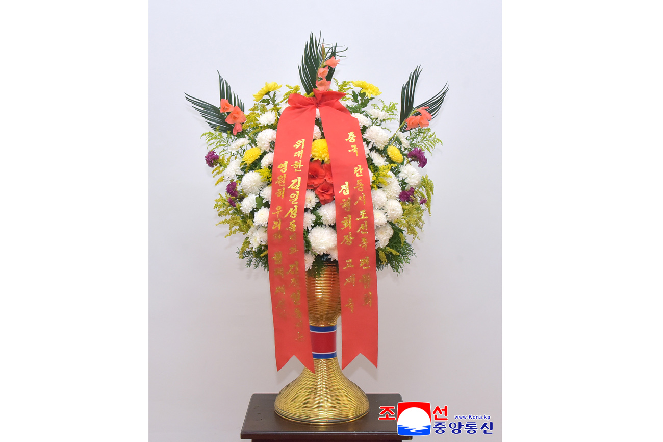 Floral baskets sent to bronze statues of great leaders Kim Il Sung and Kim Jong Il