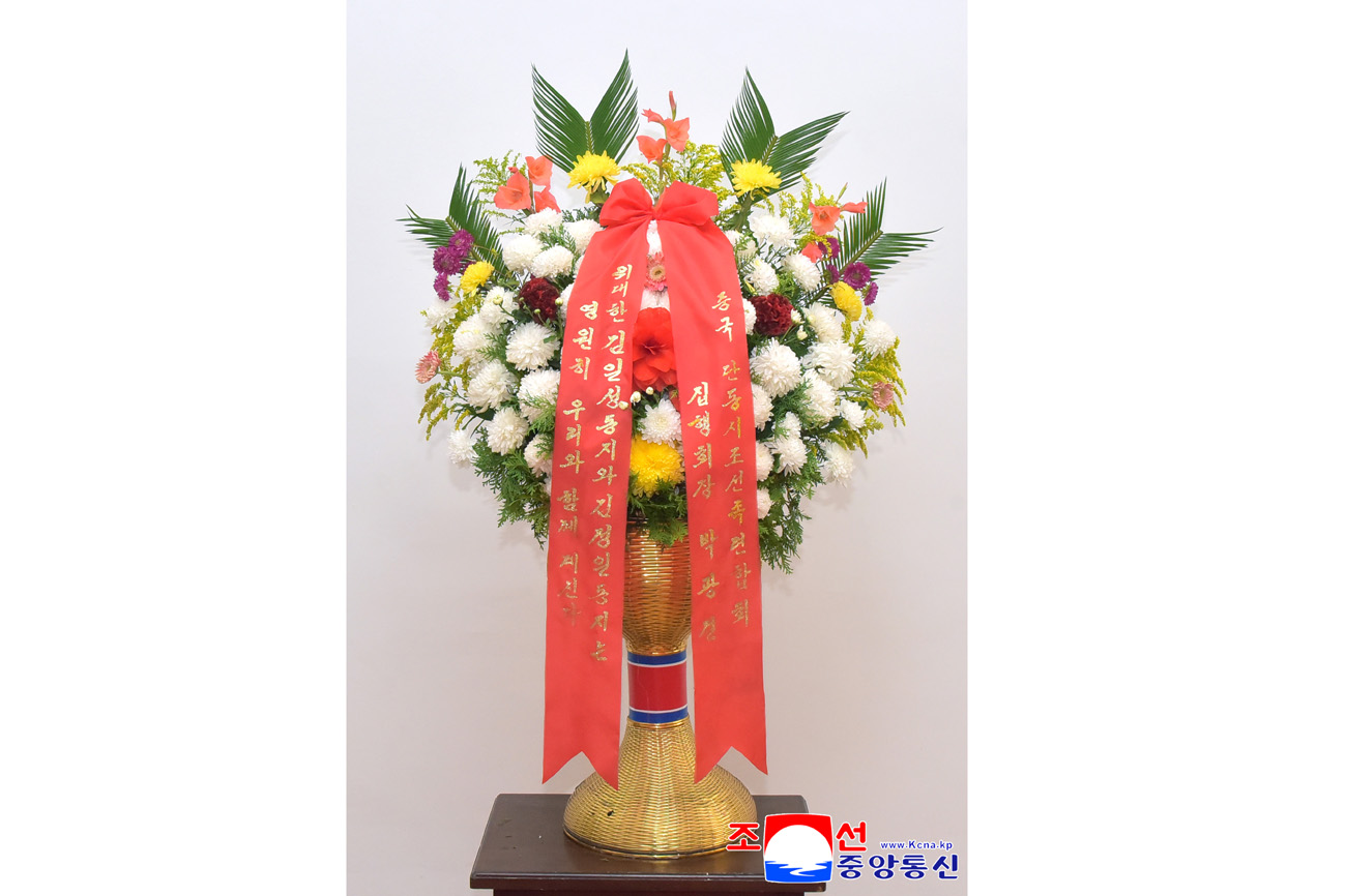 Floral baskets sent to bronze statues of great leaders Kim Il Sung and Kim Jong Il