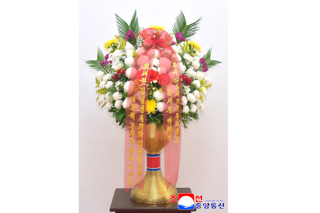 Floral baskets sent to bronze statues of great leaders Kim Il Sung and Kim Jong Il
