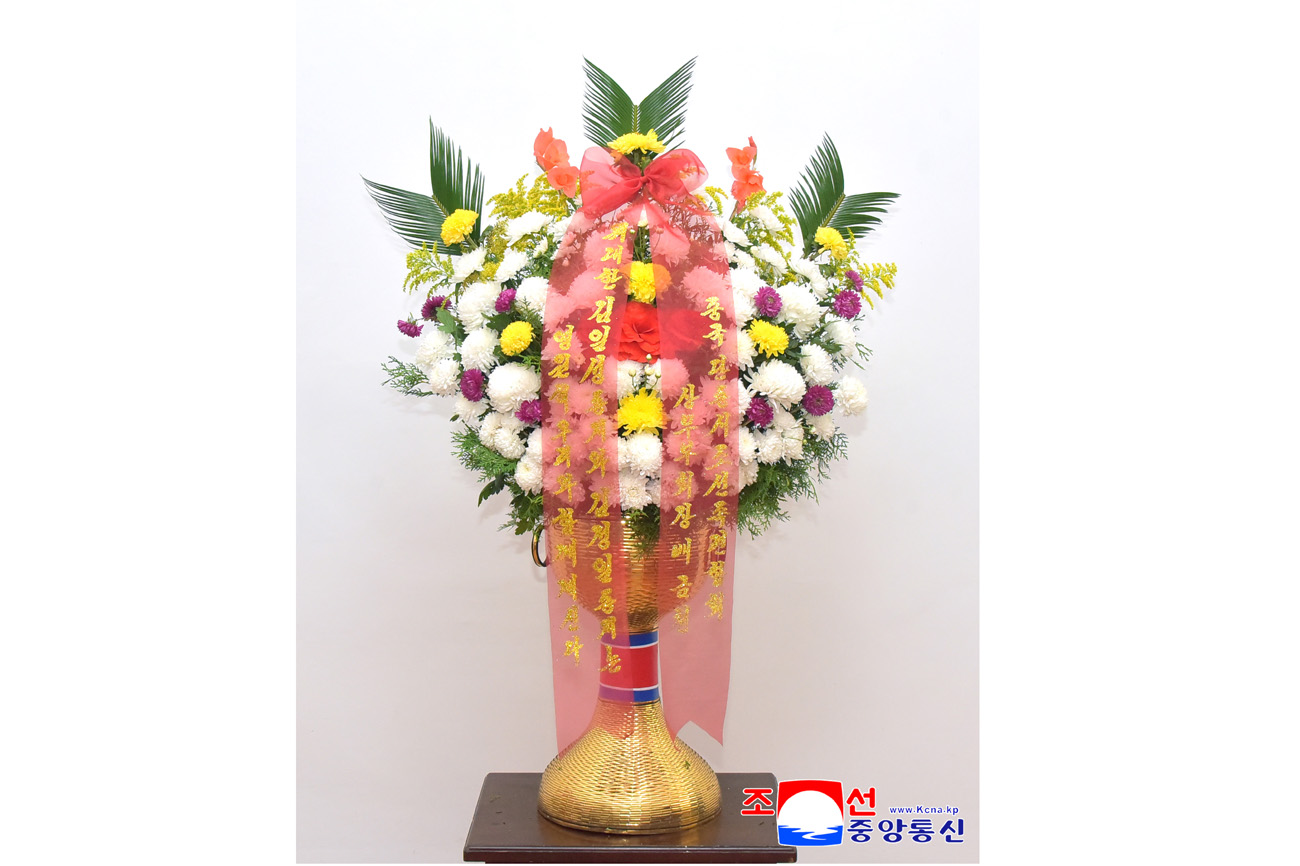 Floral baskets sent to bronze statues of great leaders Kim Il Sung and Kim Jong Il