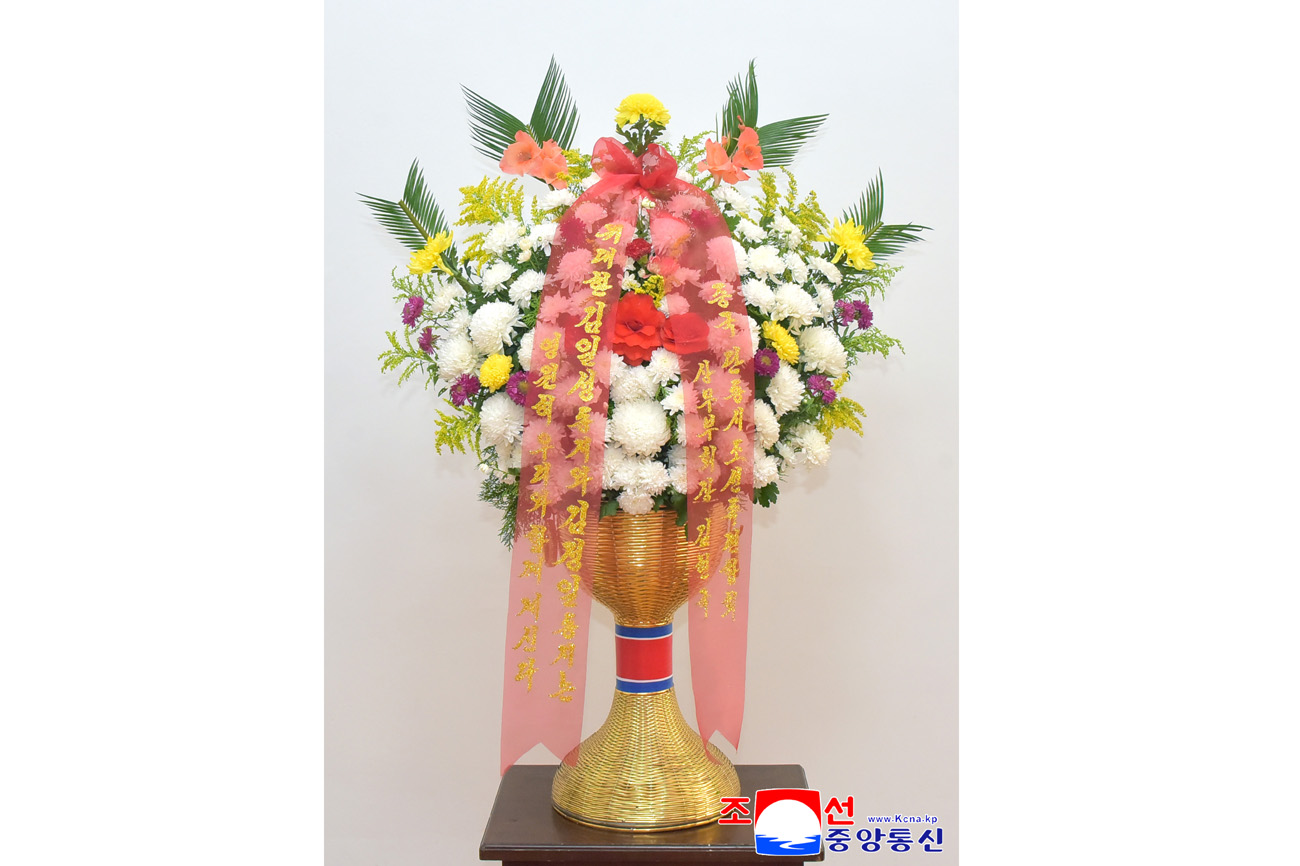 Floral baskets sent to bronze statues of great leaders Kim Il Sung and Kim Jong Il
