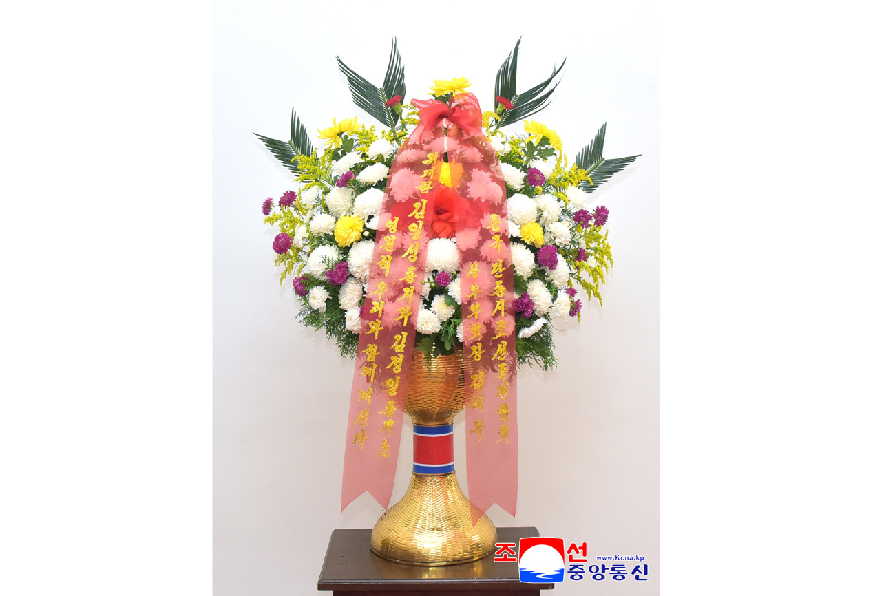 Floral baskets sent to bronze statues of great leaders Kim Il Sung and Kim Jong Il