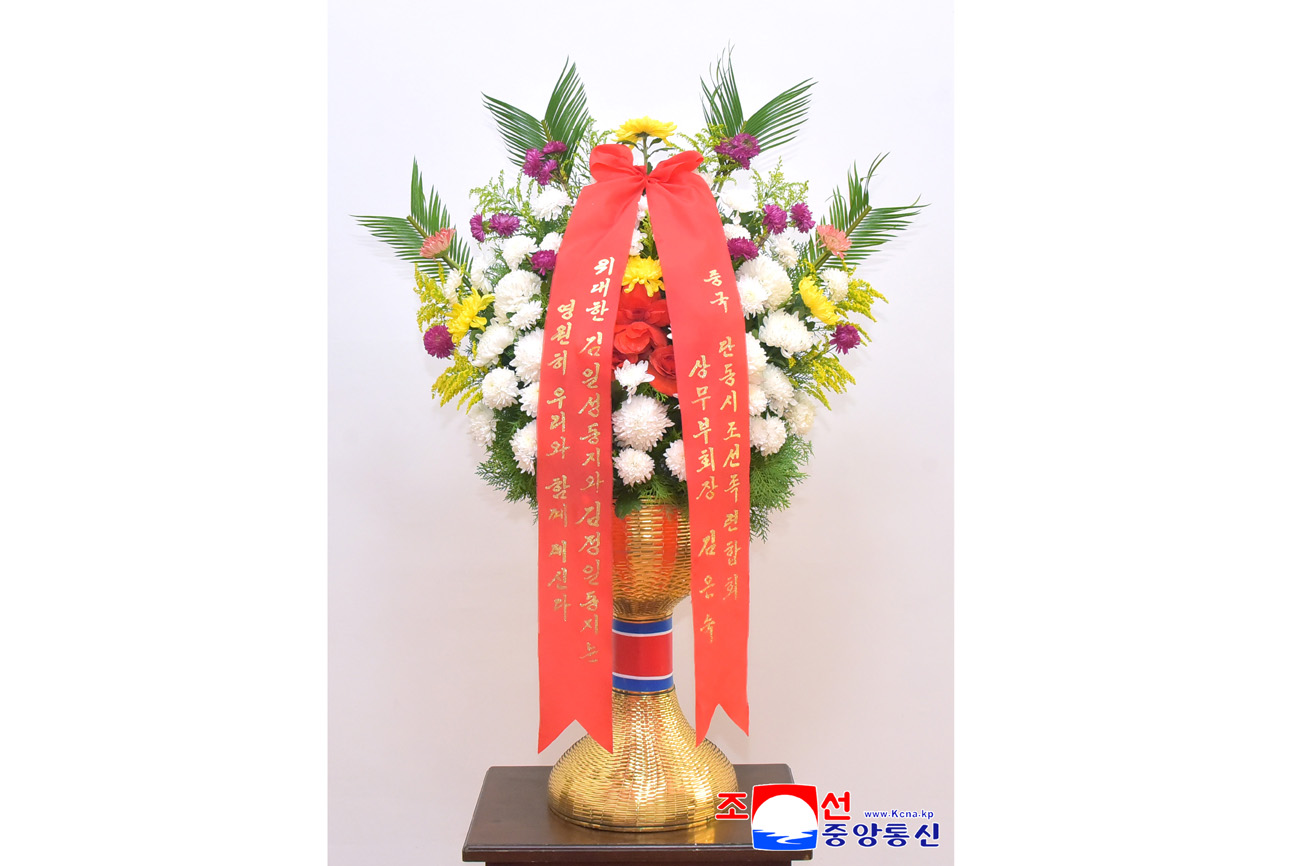 Floral baskets sent to bronze statues of great leaders Kim Il Sung and Kim Jong Il
