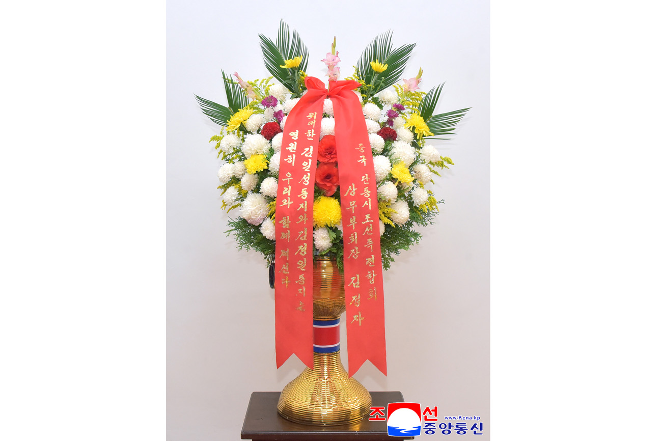 Floral baskets sent to bronze statues of great leaders Kim Il Sung and Kim Jong Il
