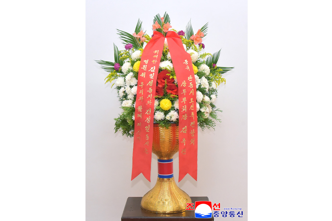 Floral baskets sent to bronze statues of great leaders Kim Il Sung and Kim Jong Il