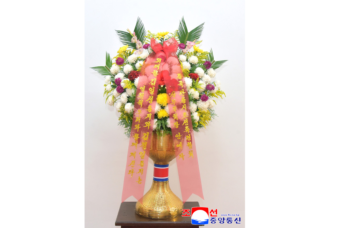 Floral baskets sent to bronze statues of great leaders Kim Il Sung and Kim Jong Il