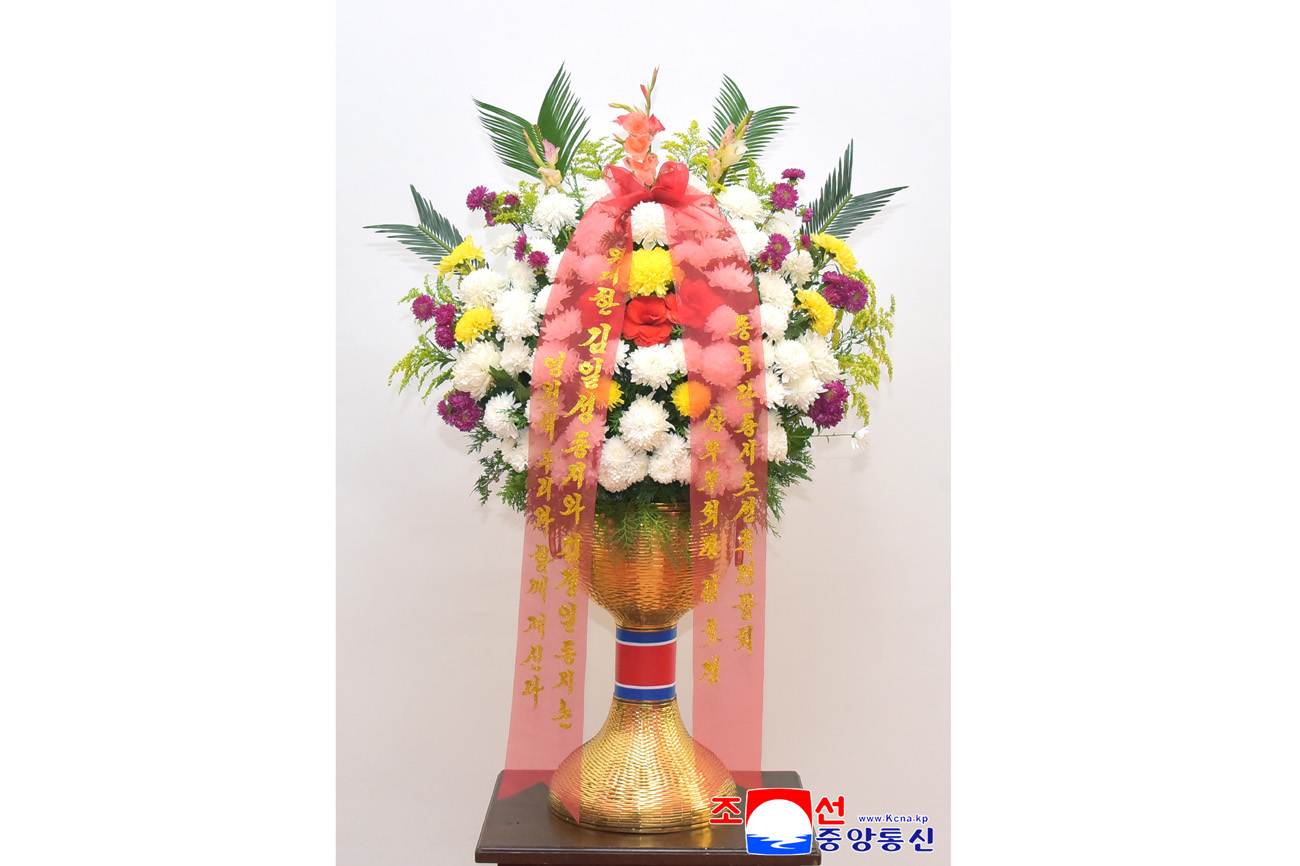 Floral baskets sent to bronze statues of great leaders Kim Il Sung and Kim Jong Il