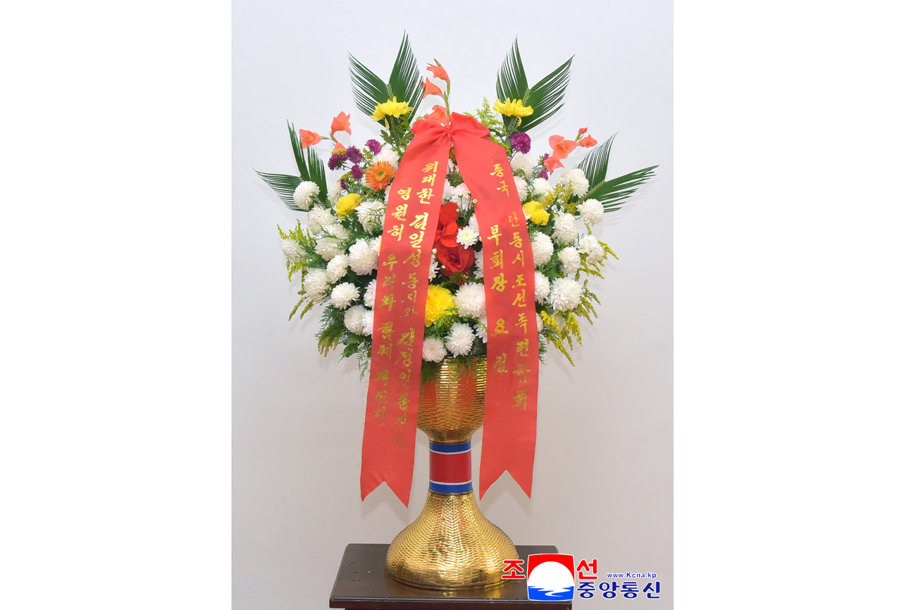 Floral baskets sent to bronze statues of great leaders Kim Il Sung and Kim Jong Il