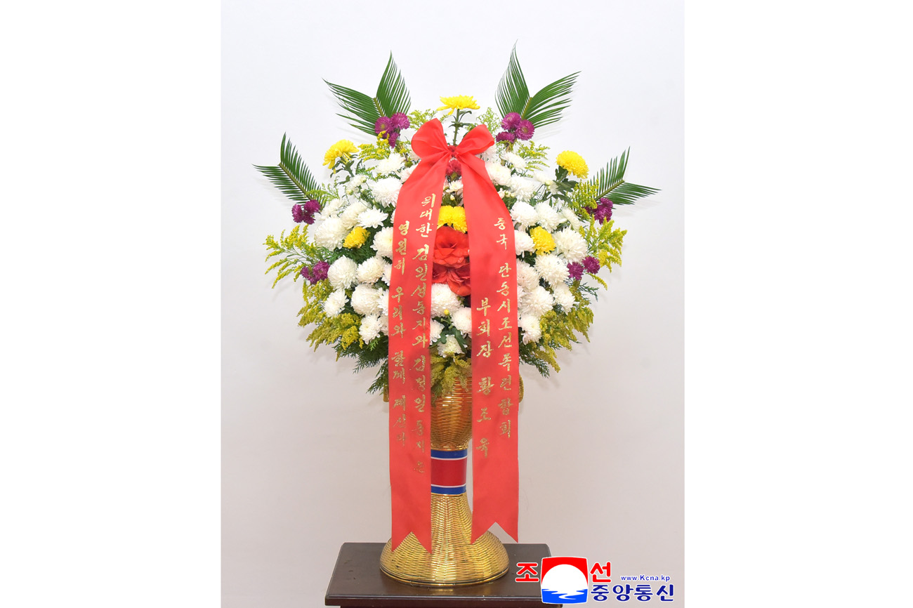 Floral baskets sent to bronze statues of great leaders Kim Il Sung and Kim Jong Il