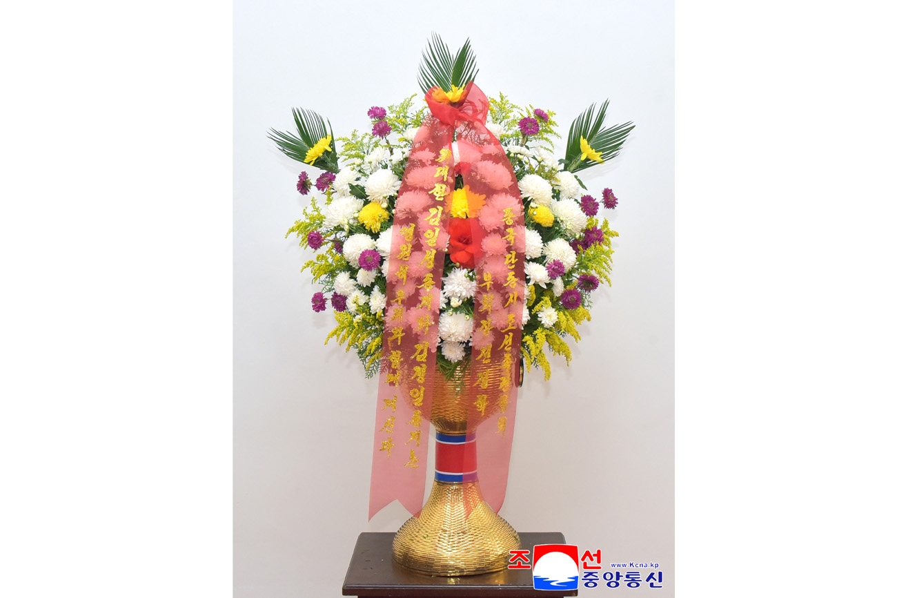 Floral baskets sent to bronze statues of great leaders Kim Il Sung and Kim Jong Il