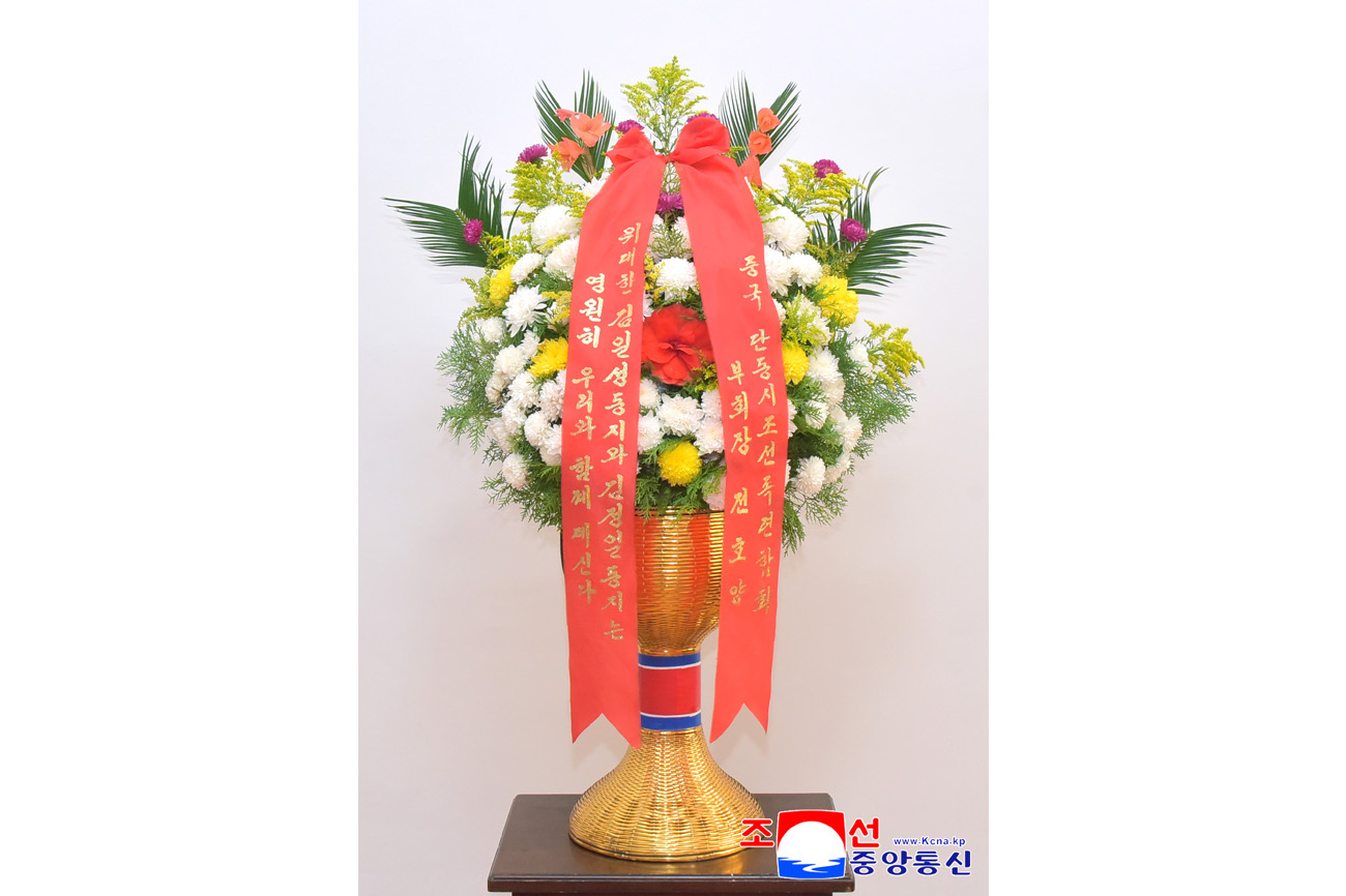 Floral baskets sent to bronze statues of great leaders Kim Il Sung and Kim Jong Il