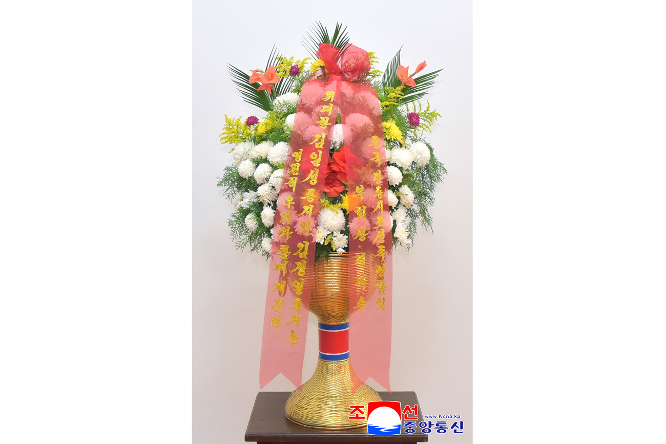 Floral baskets sent to bronze statues of great leaders Kim Il Sung and Kim Jong Il