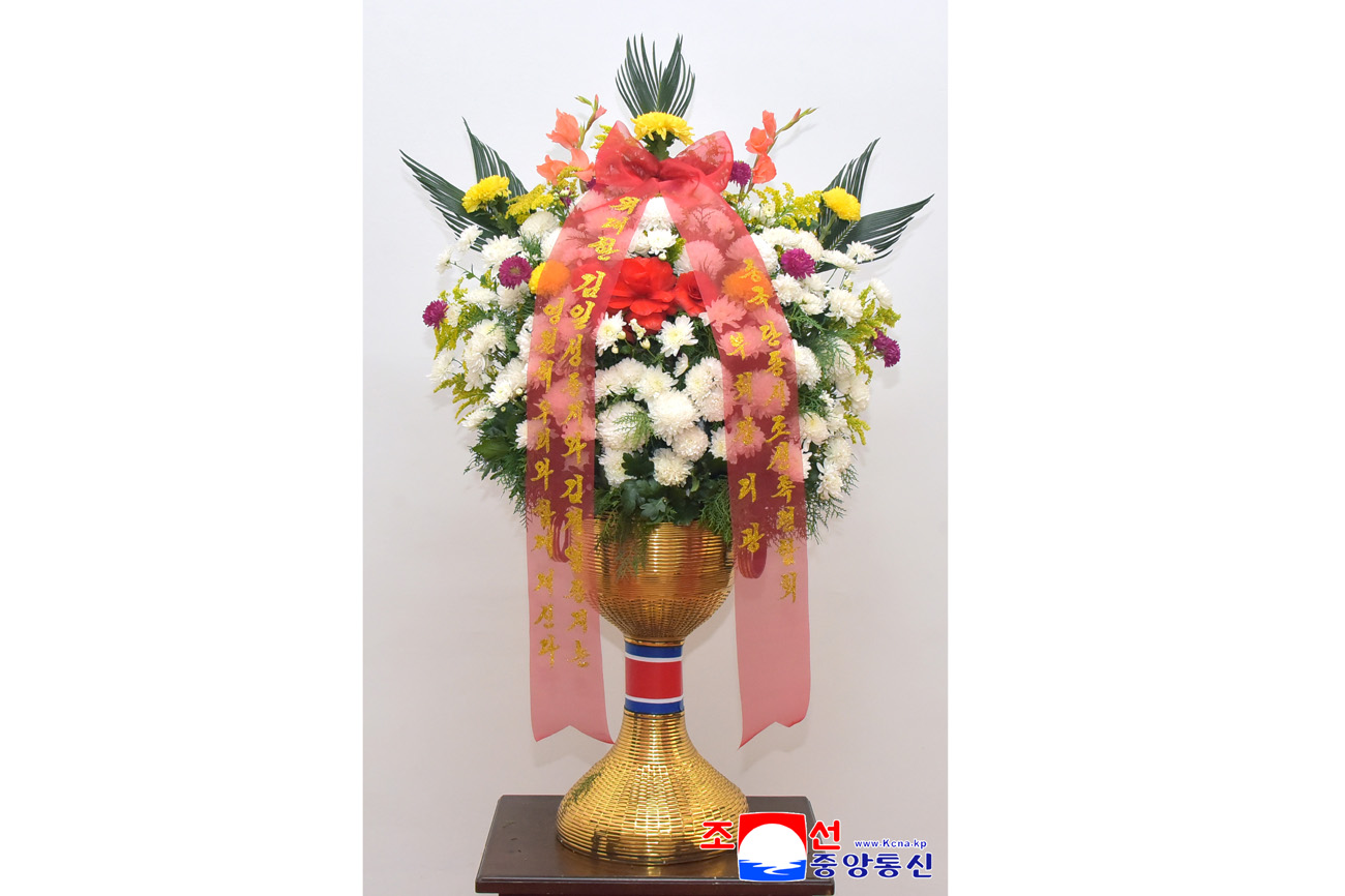 Floral baskets sent to bronze statues of great leaders Kim Il Sung and Kim Jong Il