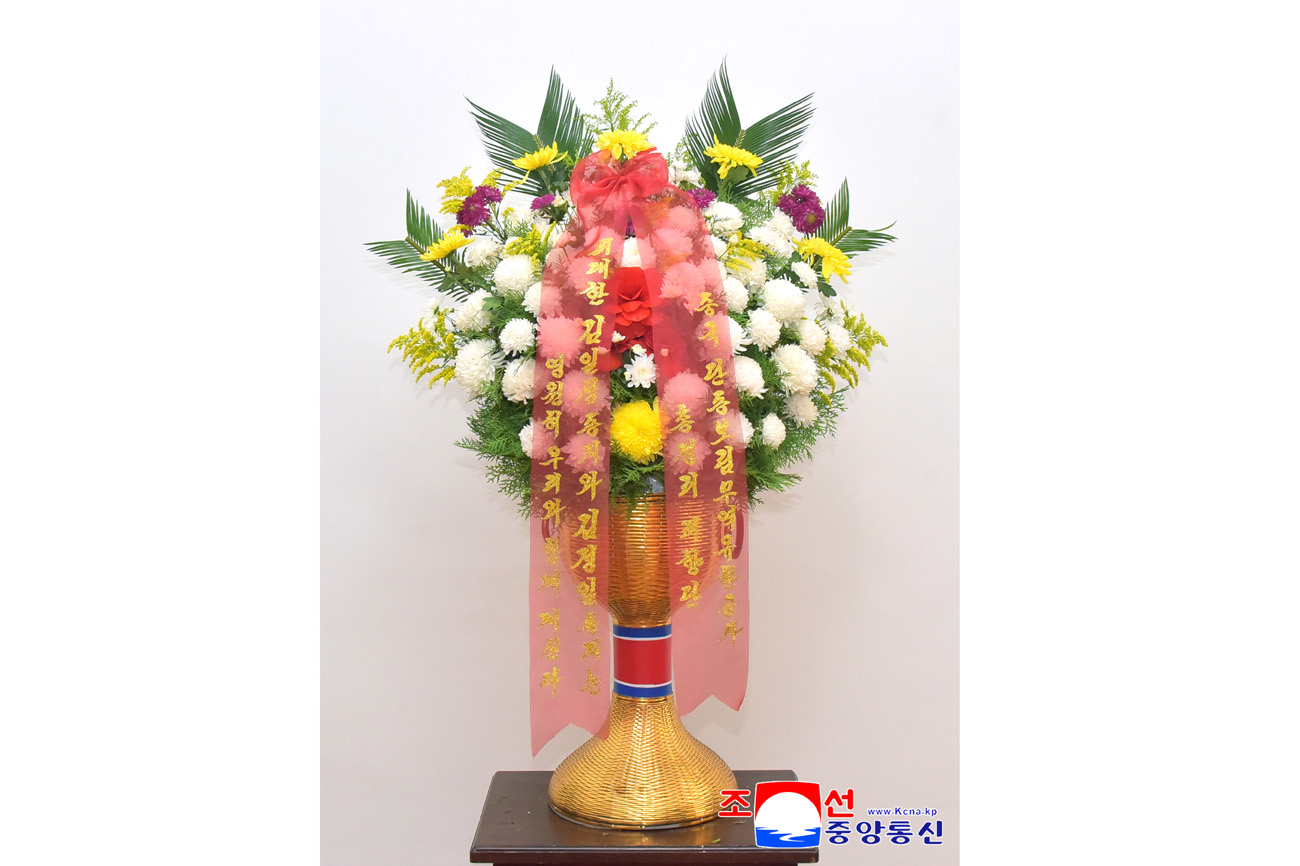 Floral baskets sent to bronze statues of great leaders Kim Il Sung and Kim Jong Il