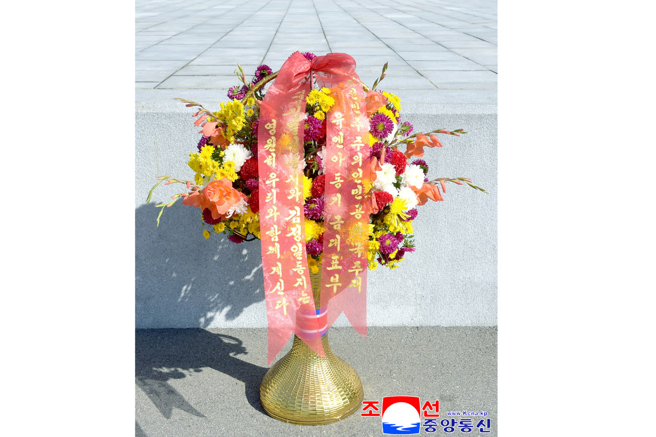 Floral baskets sent to bronze statues of great leaders Kim Il Sung and Kim Jong Il