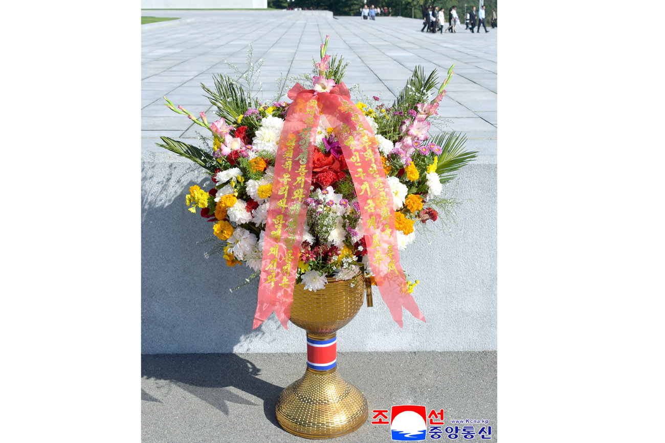 Floral baskets sent to bronze statues of great leaders Kim Il Sung and Kim Jong Il