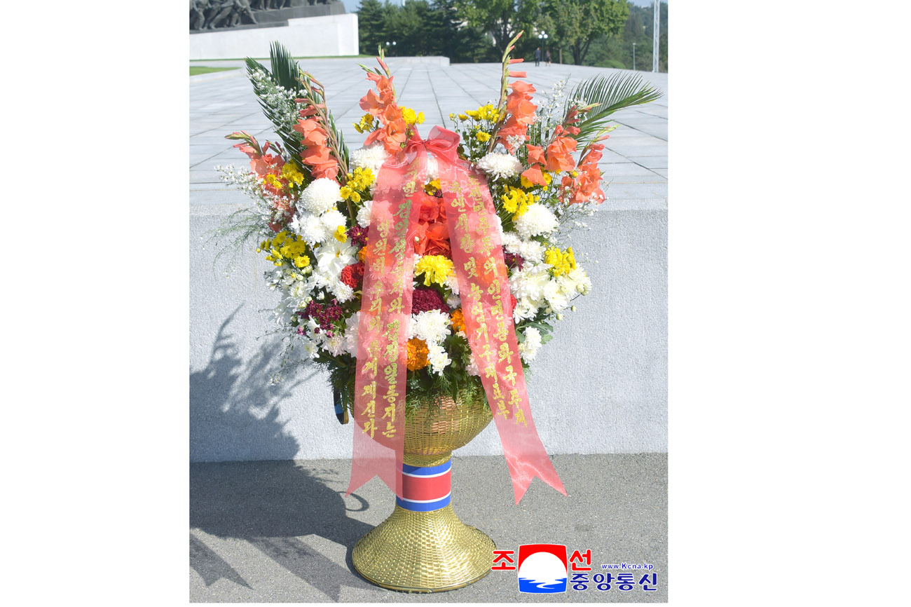 Floral baskets sent to bronze statues of great leaders Kim Il Sung and Kim Jong Il