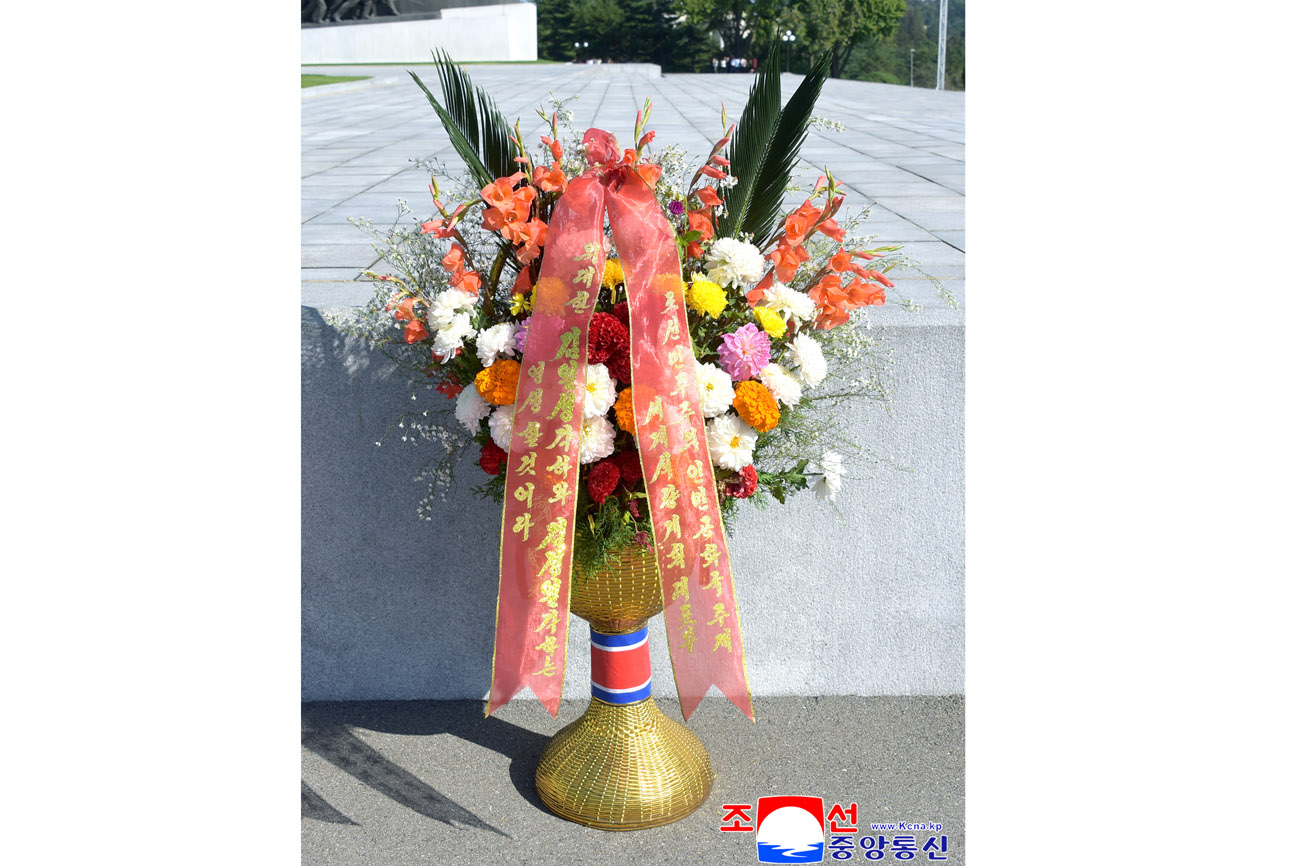 Floral baskets sent to bronze statues of great leaders Kim Il Sung and Kim Jong Il