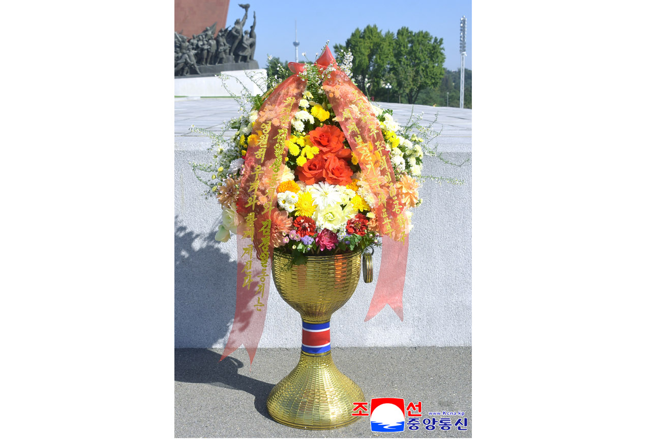 Floral baskets sent to bronze statues of great leaders Kim Il Sung and Kim Jong Il