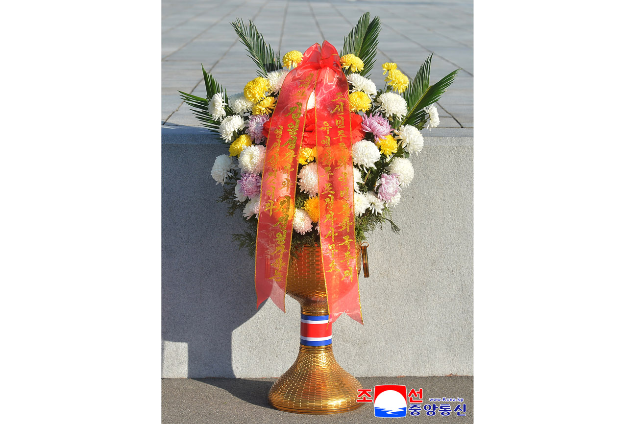 Floral baskets laid before bronze statues of great leaders Kim Il Sung and Kim Jong Il
