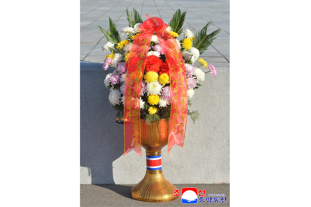 Floral baskets laid before bronze statues of great leaders Kim Il Sung and Kim Jong Il