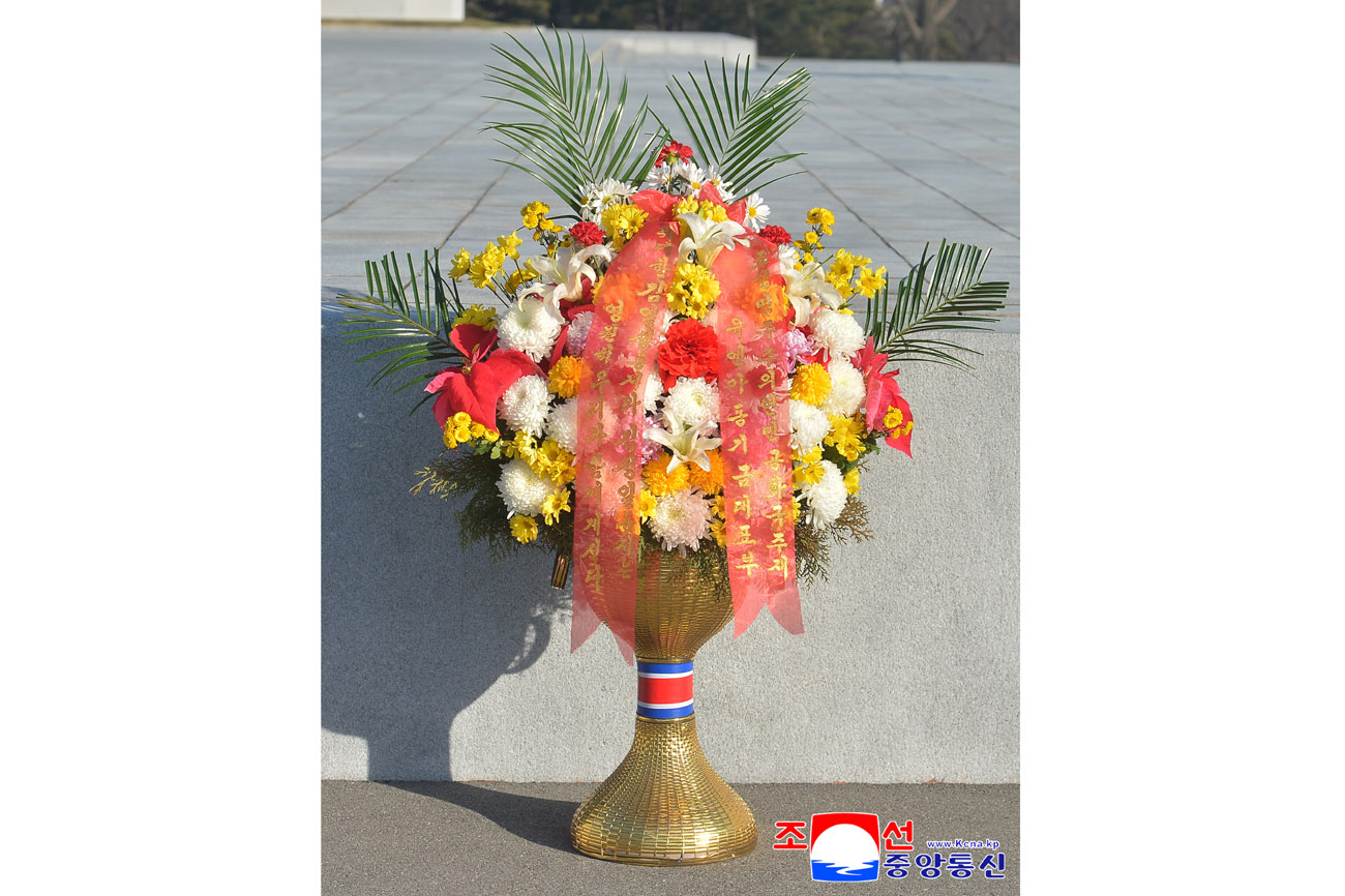 Floral baskets laid before bronze statues of great leaders Kim Il Sung and Kim Jong Il