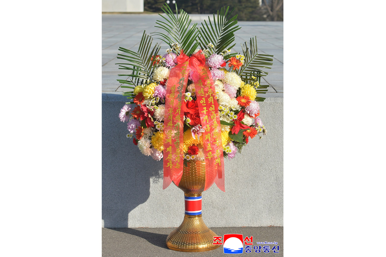 Floral baskets laid before bronze statues of great leaders Kim Il Sung and Kim Jong Il