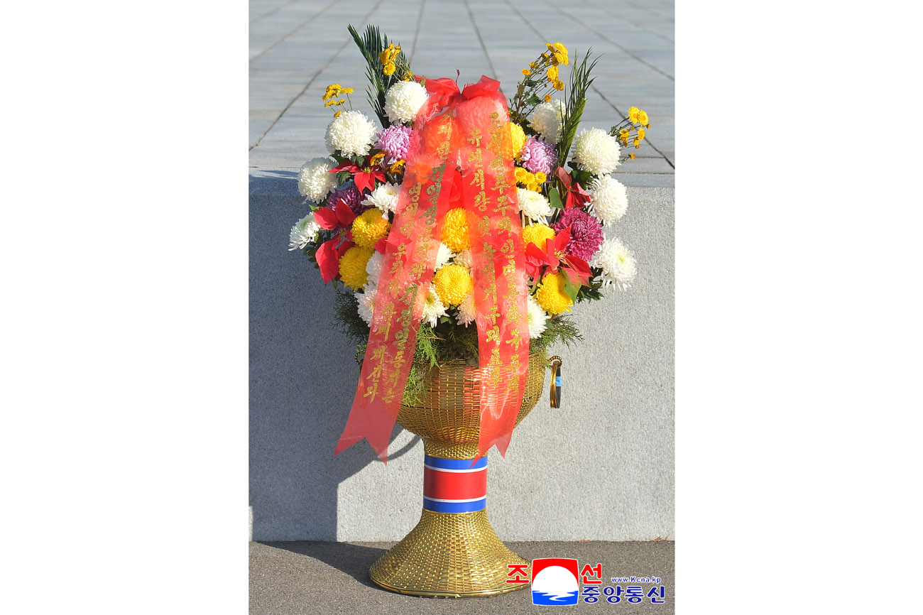 Floral baskets laid before bronze statues of great leaders Kim Il Sung and Kim Jong Il