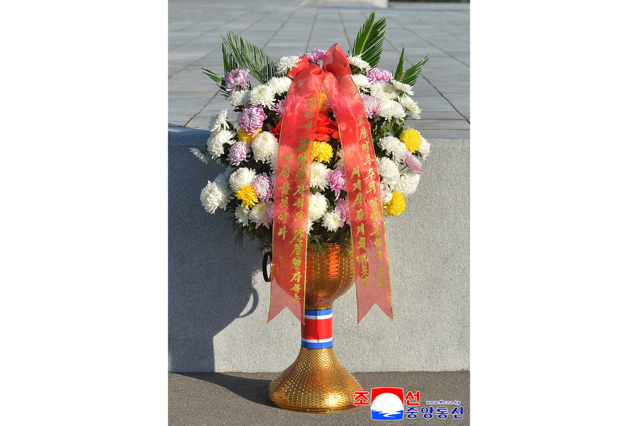 Floral baskets laid before bronze statues of great leaders Kim Il Sung and Kim Jong Il